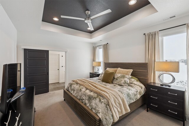 bedroom featuring recessed lighting, a ceiling fan, visible vents, and a raised ceiling