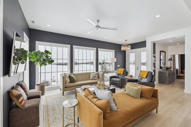 living area with light wood-style flooring, visible vents, and a wealth of natural light