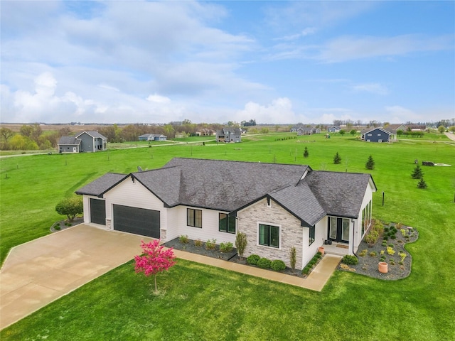 single story home with concrete driveway, a front lawn, an attached garage, and stone siding