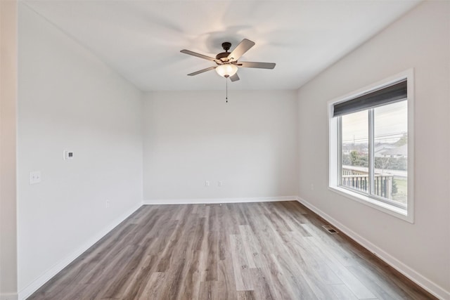 empty room with ceiling fan and wood-type flooring