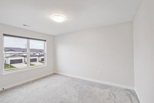 unfurnished room featuring light colored carpet