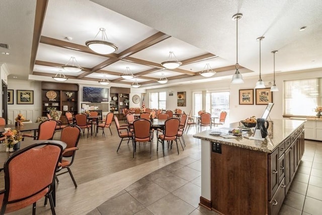 interior space featuring coffered ceiling, tile patterned floors, and beam ceiling