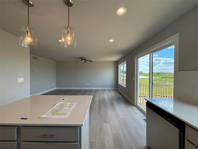 1715 Gordon Ct, Norwalk, IA 50211 - kitchen featuring ceiling fan, gray cabinets, light wood-type flooring, light countertops, and stainless steel dishwasher