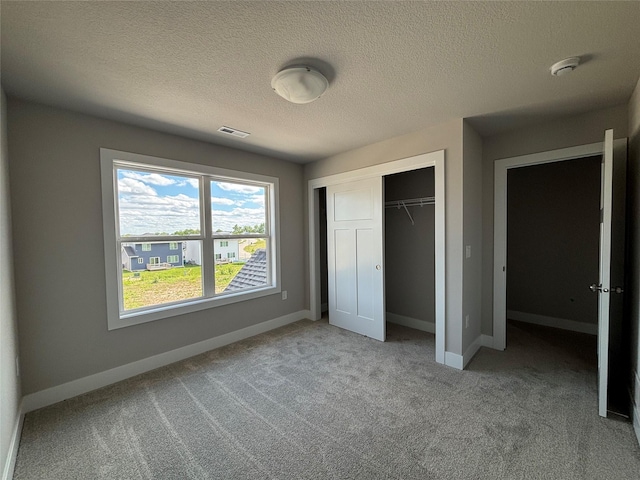 1715 Gordon Ct, Norwalk, IA 50211 - unfurnished bedroom featuring light carpet, a closet, baseboards, and a textured ceiling