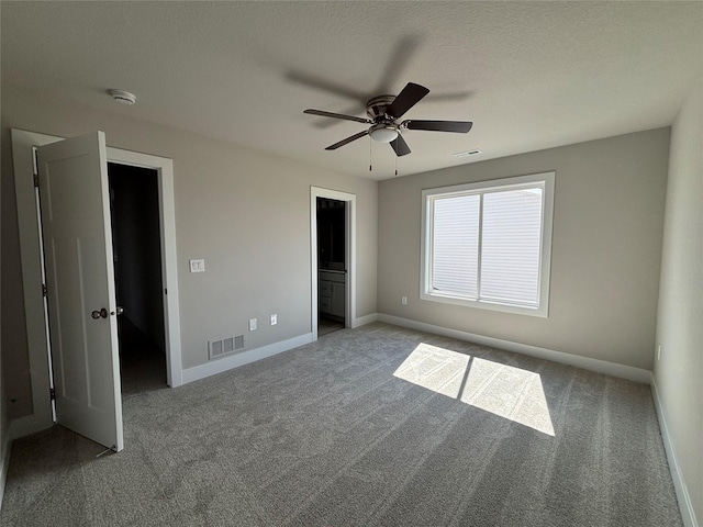 1715 Gordon Ct, Norwalk, IA 50211 - unfurnished bedroom featuring carpet, baseboards, ceiling fan, and ensuite bath