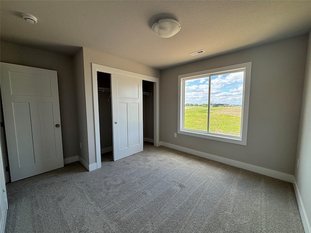 1715 Gordon Ct, Norwalk, IA 50211 - unfurnished bedroom with carpet floors, baseboards, a closet, and a textured ceiling