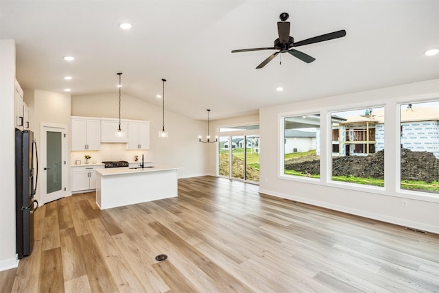 18258 Hidden Knl, Clive, IA 50325 - unfurnished living room with vaulted ceiling, light wood-style floors, recessed lighting, a sink, and a ceiling fan