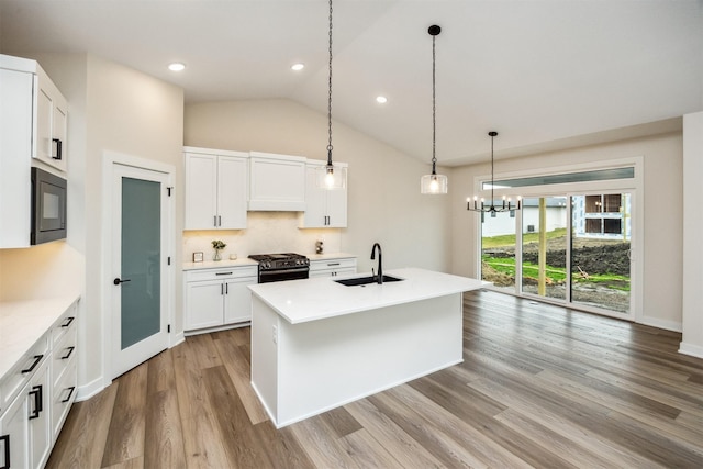 18258 Hidden Knl, Clive, IA 50325 - kitchen featuring a sink, black appliances, light wood-style flooring, vaulted ceiling, and white cabinetry