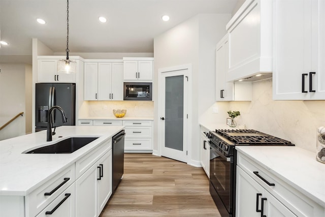 18258 Hidden Knl, Clive, IA 50325 - kitchen featuring black appliances, a sink, pendant lighting, light wood-style floors, and backsplash