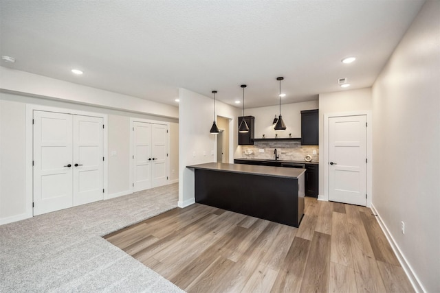 18258 Hidden Knl, Clive, IA 50325 - kitchen with backsplash, light wood finished floors, baseboards, recessed lighting, and a peninsula
