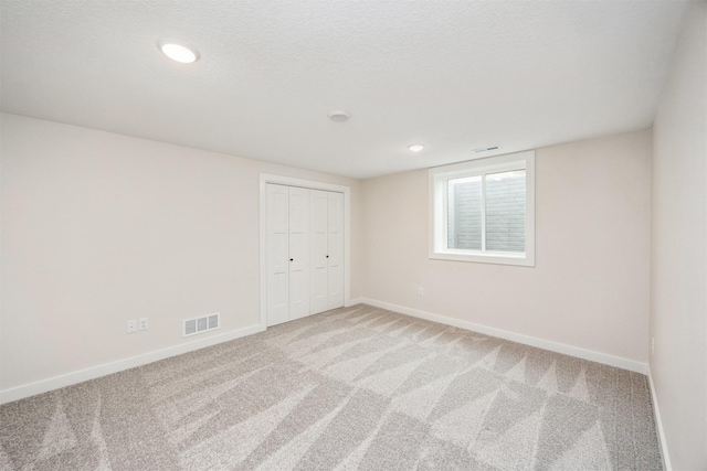 18258 Hidden Knl, Clive, IA 50325 - unfurnished bedroom with light colored carpet, baseboards, a closet, and recessed lighting