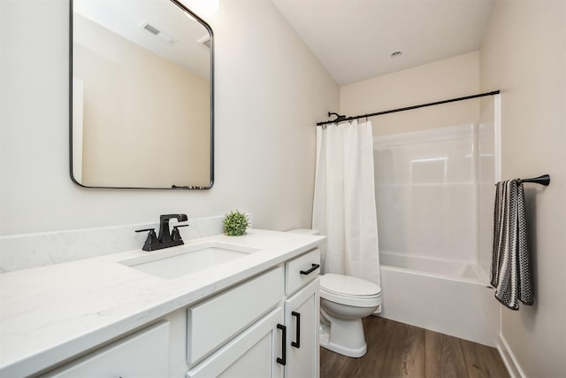 18258 Hidden Knl, Clive, IA 50325 - full bathroom featuring wood finished floors, toilet, vanity, and shower / tub combo