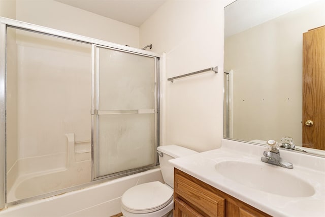 full bathroom featuring enclosed tub / shower combo, vanity, and toilet