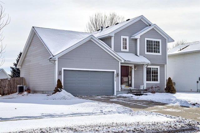 view of property with a garage and central AC