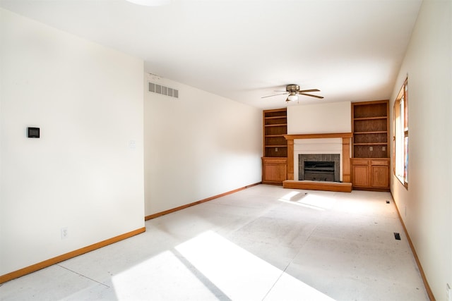 unfurnished living room with built in features and ceiling fan