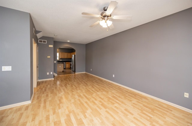 unfurnished living room featuring ceiling fan and light wood-type flooring