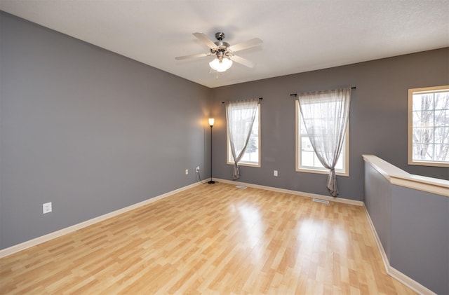 spare room with ceiling fan and light hardwood / wood-style flooring