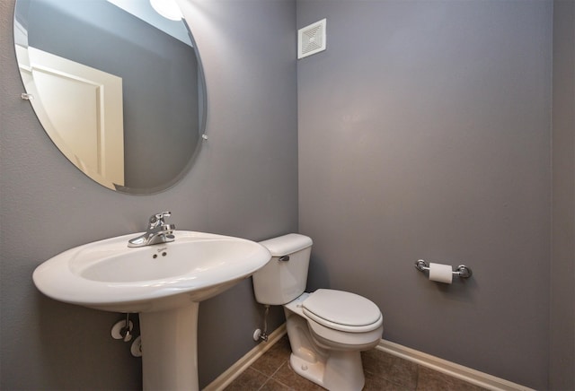 bathroom featuring tile patterned flooring and toilet