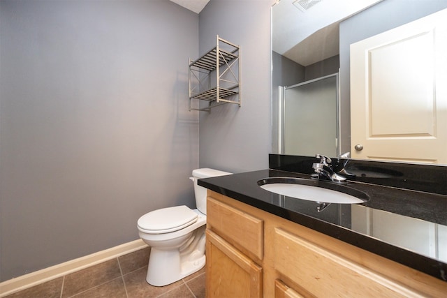 bathroom with tile patterned flooring, vanity, toilet, and a shower with shower door