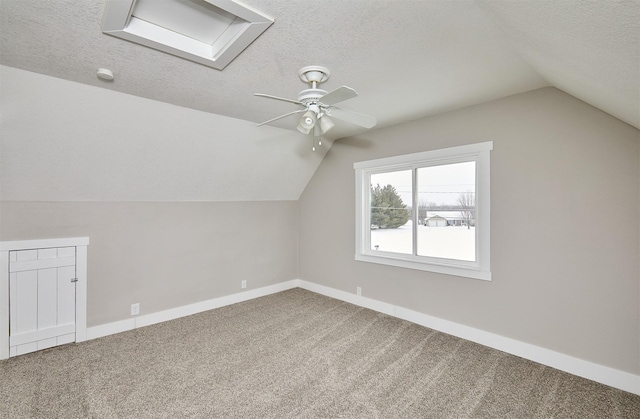 bonus room with ceiling fan, carpet floors, a textured ceiling, and lofted ceiling