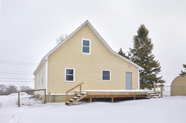 view of snow covered rear of property