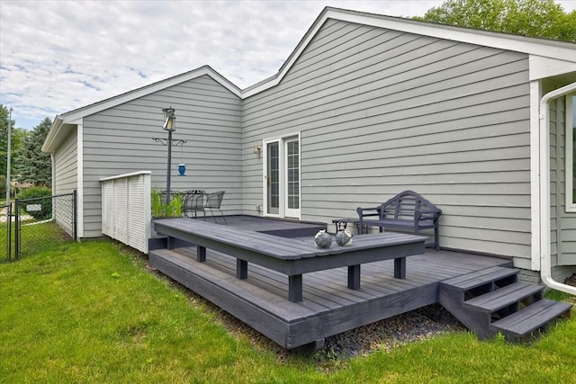 back of property with a yard and a wooden deck