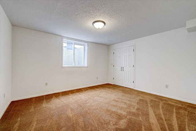 spare room with carpet and a textured ceiling