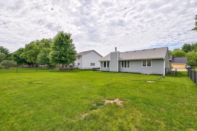 rear view of house featuring a yard