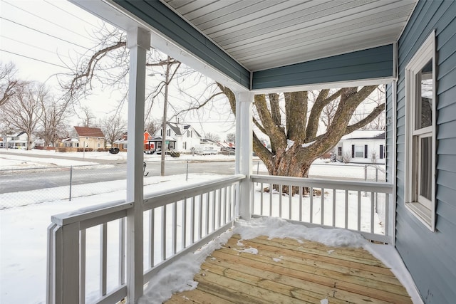 snow covered deck with covered porch