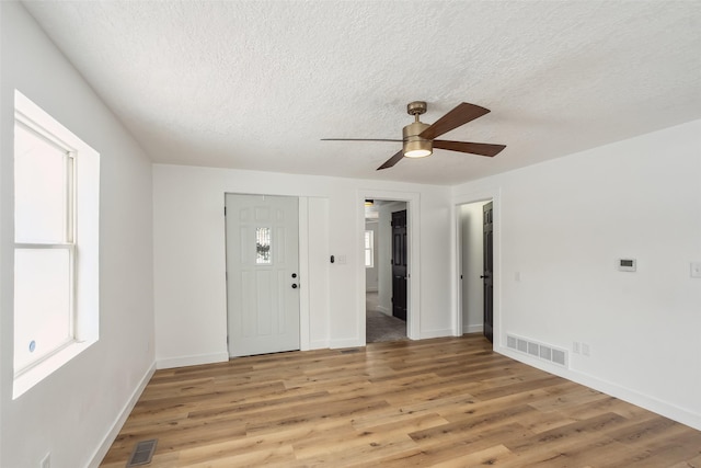 entryway with a textured ceiling and hardwood / wood-style floors