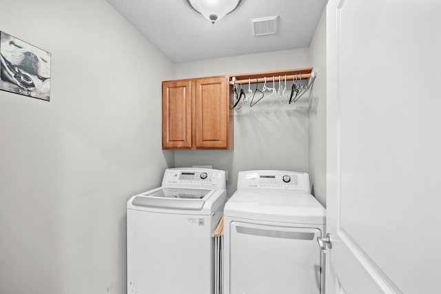 laundry area with cabinets and separate washer and dryer