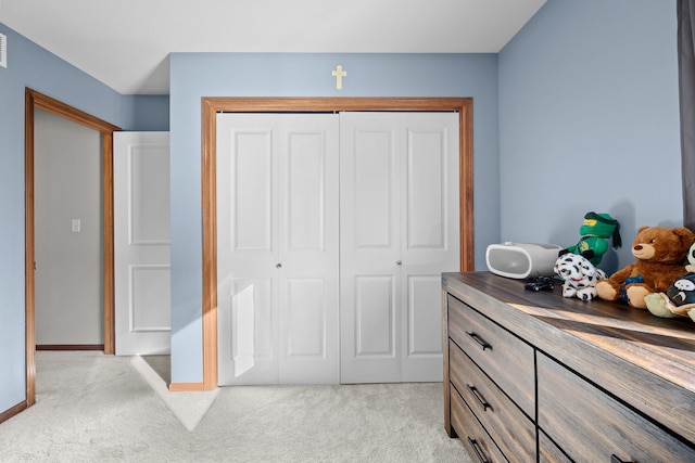 carpeted bedroom with a closet