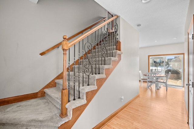 stairway with hardwood / wood-style floors