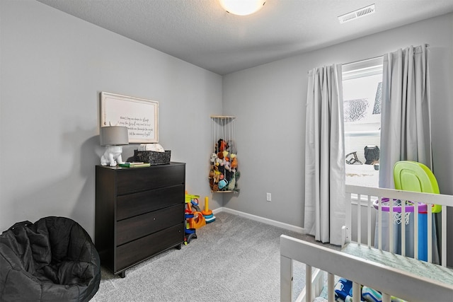 carpeted bedroom with a textured ceiling