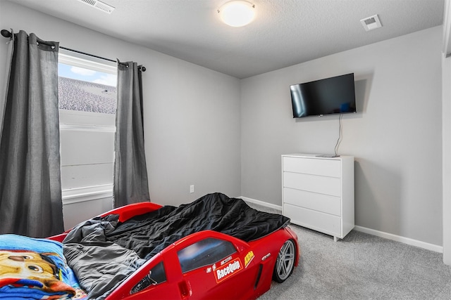 carpeted bedroom featuring a textured ceiling