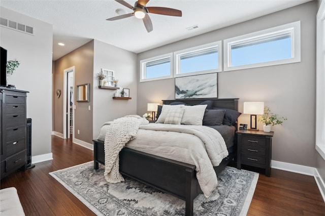 bedroom with ceiling fan and dark hardwood / wood-style floors