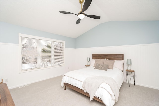 carpeted bedroom featuring vaulted ceiling and ceiling fan