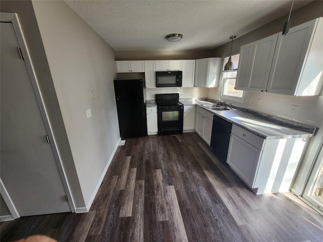 kitchen with black appliances, decorative light fixtures, decorative backsplash, sink, and white cabinetry