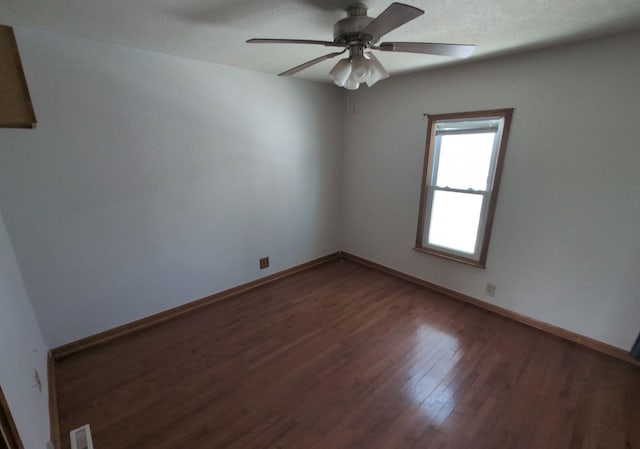 unfurnished room featuring a textured ceiling, ceiling fan, and dark hardwood / wood-style floors