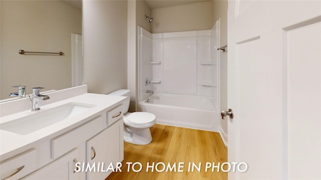 full bathroom featuring shower / tub combination, wood-type flooring, vanity, and toilet