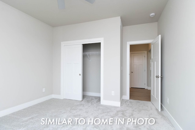 unfurnished bedroom with a closet, baseboards, ceiling fan, and carpet