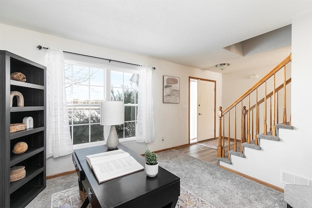 living room featuring carpet flooring and a textured ceiling