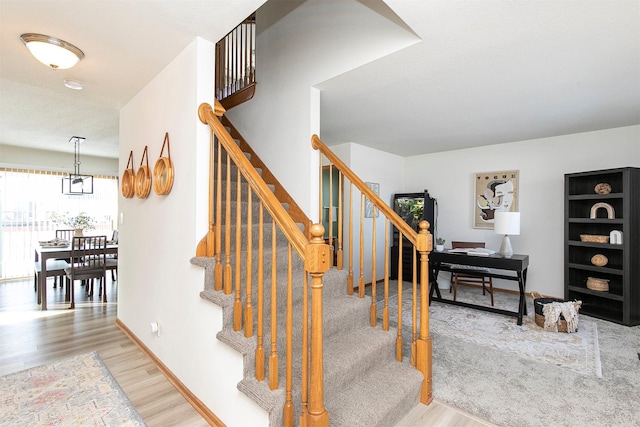 staircase featuring wood-type flooring