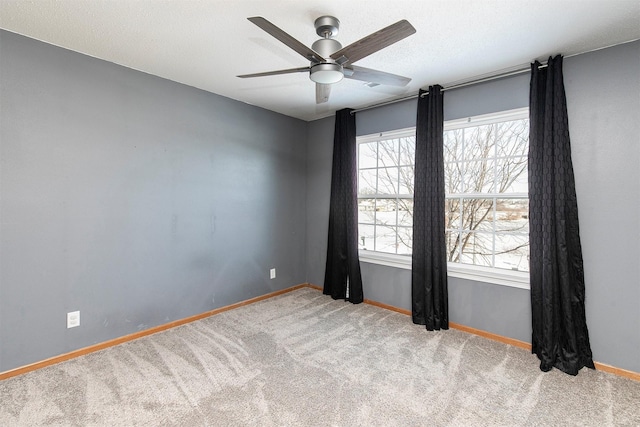 carpeted empty room with a textured ceiling and ceiling fan