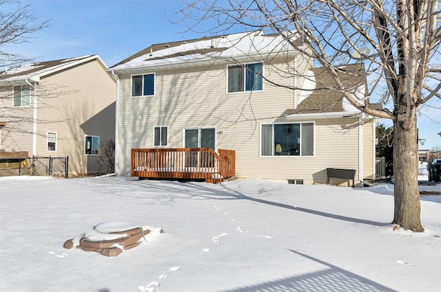 snow covered house with a deck