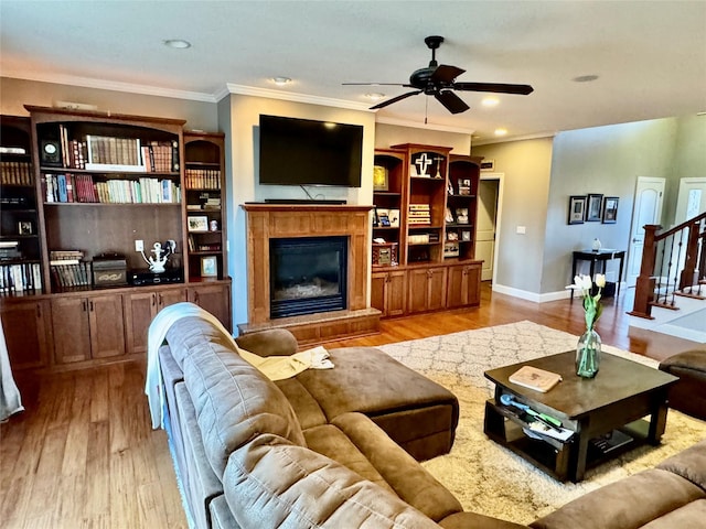 living room featuring ceiling fan, light hardwood / wood-style flooring, and crown molding