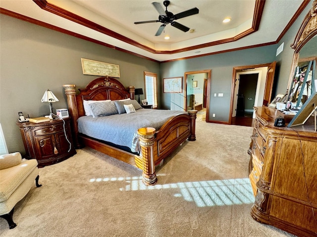 carpeted bedroom with crown molding, ceiling fan, and a raised ceiling