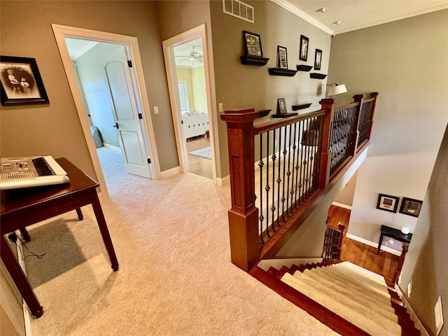 hall with light carpet and crown molding