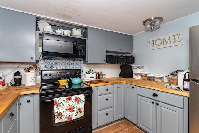 2003 Carroll St, Boone, IA 50036 - kitchen with wood counters, black appliances, and gray cabinetry