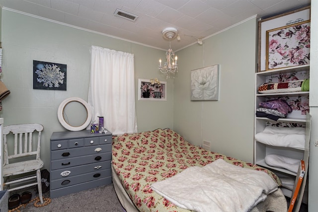 2003 Carroll St, Boone, IA 50036 - carpeted bedroom featuring visible vents, ornamental molding, and a notable chandelier
